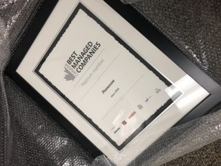 A framed certificate wrapped in bubble wrap, labeled 