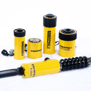Five yellow and black Enerpac Cylinders & Lifting Equipment pieces are displayed on a white background—four stand upright, while one long cylinder with handles is positioned horizontally in front.