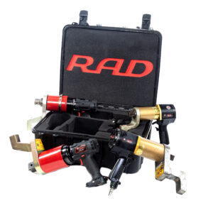 Three industrial torque wrenches with red and gold accents are arranged in front of an open black carrying case labeled "RAD" in red letters. The case has foam inserts and a handle.